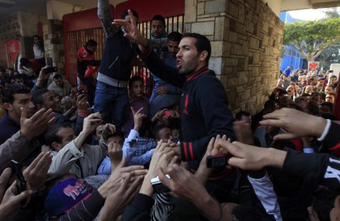 Egyptian Al-Ahly football player Mohammed Abu Trika shots slogans as fans gather outside Al-Ahly club in Cairo on February 2, 2012 before marching to the ministry of interior in protest against the previous day's deadly riot after a football match. Egypt began three days of mourning after 74 people were killed in an eruption of violence at a football match between Al-Ahly and Al-Masry clubs that sparked new anger against the military rulers for failing to ensure security. AFP PHOTO/MAHMUD HAMS (Photo credit should read MAHMUD HAMS/AFP/Getty Images)