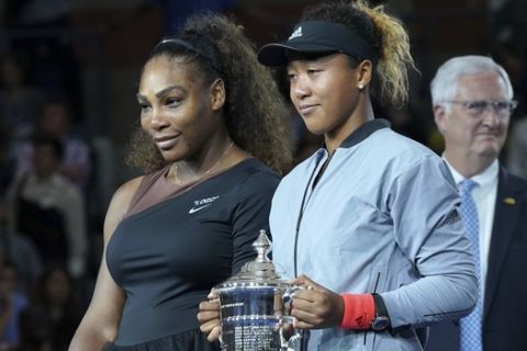 Serena Williams, left, and Naomi Osaka, of Japan, pose for photos during the trophy ceremony after Osaka defeated Williams in the women's finals of the U.S. Open tennis tournament at the USTA Billie Jean King National Tennis Center on Saturday, Sept. 8, 2018, in New York. (Photo by Greg Allen/Invision/AP)
