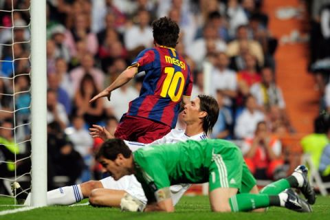 Barcelona's Argentinian forward Lionel Messi (top) celebrates after scoring next to Real Madrid's defender Sergio Ramos (C) and Real Madrid's goalkeeper and captain Iker Casillas (down) during the Champions League semi-final first leg football match between Real Madrid and Barcelona at the Santiago Bernabeu stadium in Madrid on April 27, 2011. AFP PHOTO/ DANI POZO (Photo credit should read DANI POZO/AFP/Getty Images)