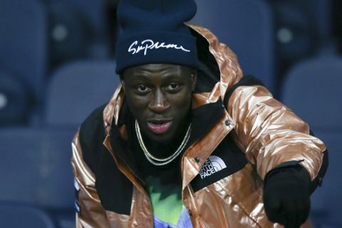 Manchester City defender Benjamin Mendy is pictured on the tribune during the Champions League Group F soccer match between Manchester City and Hoffenheim at the Etihad stadium in Manchester, England, Wednesday, Dec. 12, 2018. (AP Photo/Dave Thompson)