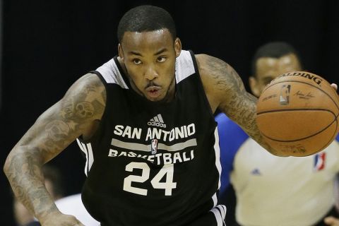 The San Antonio Spurs' Marcus Denmon drives up the court the New Orleans Pelicans during an NBA summer league basketball game Monday, July 14, 2014, in Las Vegas. (AP Photo/John Locher)