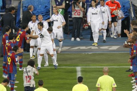 FC Barcelona players form a passage of honor for Real Madrid players prior their Spanish League soccer match at the Santiago Bernabeu stadium in Madrid, Wednesday, May 7, 2008, three days after Real Madrid won their 31st Spanish league title. (AP Photo/Daniel Ochoa de Olza)