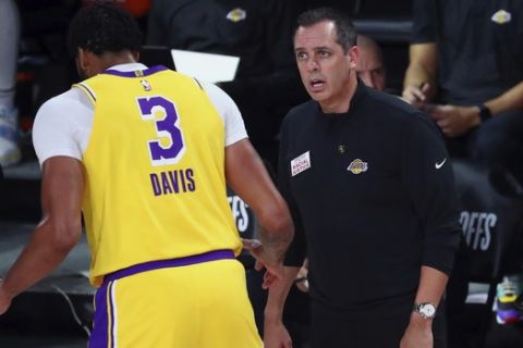 Los Angeles Lakers head coach Frank Vogel, right, talks with forward Anthony Davis (3) during the first half of Game 2 of an NBA basketball first-round playoff series against the Portland Trail Blazers, Thursday, Aug. 20, 2020, in Lake Buena Vista, Fla. (Kim Klement/Pool Photo via AP)