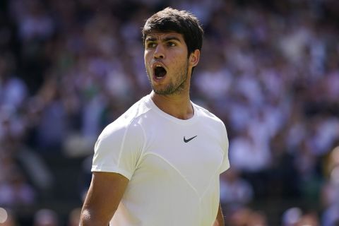 Spain's Carlos Alcaraz reacts after winning the second set against Alexandre Muller of France in a men's singles match on day five of the Wimbledon tennis championships in London, Friday, July 7, 2023. (AP Photo/Alberto Pezzali)