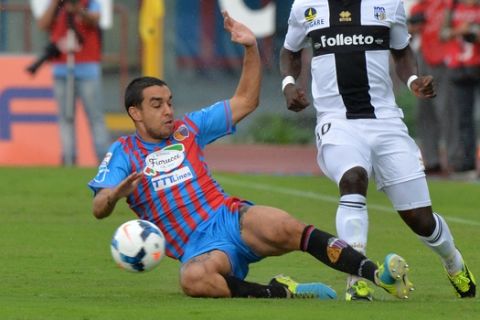 Parma midfielder Afriyie Acquah, of Ghana, right, is tackled by Catania defender Giuseppe Bellusci during the Serie A soccer match between Catania and Parma at the Angelo Massimino stadium in Catania, Italy, Sunday, Sept. 22, 2013. (AP Photo/Carmelo Imbesi)