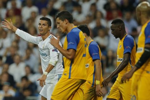 Real Madrid's Cristiano Ronaldo, left, reacts during a Champions League group H soccer match between Real Madrid and Apoel Nicosia at the Santiago Bernabeu stadium in Madrid, Spain, Wednesday, Sept. 13, 2017. (AP Photo/Paul White)