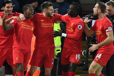 Liverpool's Dutch midfielder Georginio Wijnaldum (2nd L) celebrates with teammates after scoring the opening goal of the English Premier League football match between Liverpool and Manchester City at Anfield in Liverpool, north west England on December 31, 2016. / AFP / Paul ELLIS / RESTRICTED TO EDITORIAL USE. No use with unauthorized audio, video, data, fixture lists, club/league logos or 'live' services. Online in-match use limited to 75 images, no video emulation. No use in betting, games or single club/league/player publications.  /         (Photo credit should read PAUL ELLIS/AFP/Getty Images)