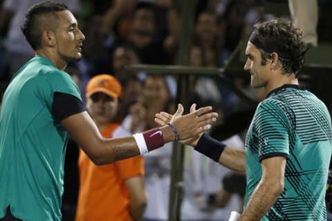 Roger Federer, of Switzerland, right, and Nick Kyrgios, of Australia, congratulate each other after Federer defeated Kyrgios 7-6 (9), 6-7 (9), 7-6 (5) during a tennis match at the Miami Open, Friday, March 31, 2017 in Key Biscayne, Fla. (AP Photo/Wilfredo Lee)
