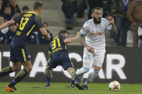 Marseille's Kostas Mitroglou, right, is tackled by Leizig's Diego Demme during the Europa League quarter final second leg soccer match between and Olympique Marseille and RB Leipzig at the Velodrome stadium in Marseille, southern France, Thursday, April 12, 2018. (AP Photo/Claude Paris)