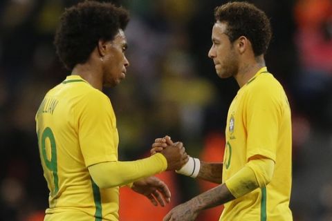 Brazil's Willian, left, shakes hands with teammate Neymar after the international friendly soccer match between England and Brazil at Wembley stadium in London, Britain, Tuesday, Nov. 14, 2017. (AP Photo/Alastair Grant)