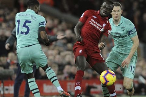 Liverpool's Sadia Mane vies for the ball with Arsenal's Ainsley Maitland-Niles during the English Premier League soccer match between Liverpool and Arsenal at Anfield in Liverpool, England, Saturday, Dec. 29, 2018. (AP Photo/Rui Vieira)
