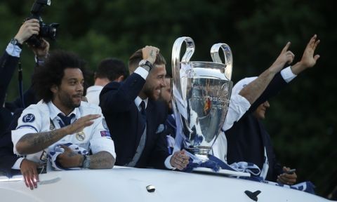 Real Madrid players arrive on an open-topped bus to Cibeles square to celebrate after winning the Champions League final, Madrid, Spain, Sunday June 4, 2017. Real Madrid became the first team in the Champions League era to win back-to-back titles with their 4-1 victory over Juventus in Cardiff Saturday. (AP Photo/Paul White)