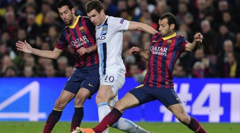 Manchester City's Bosnian striker Edin Dzeko (C) vies with Barcelona's midfielder Sergio Busquets (L) and Barcelona's Argentinian midfielder Javier Mascherano during the UEFA Champions League round of 16 second leg football match FC Barcelona vs Manchester City at the Camp Nou stadium in Barcelona on March 12, 2014.  AFP PHOTO / JOSEP LAGO        (Photo credit should read JOSEP LAGO/AFP/Getty Images)