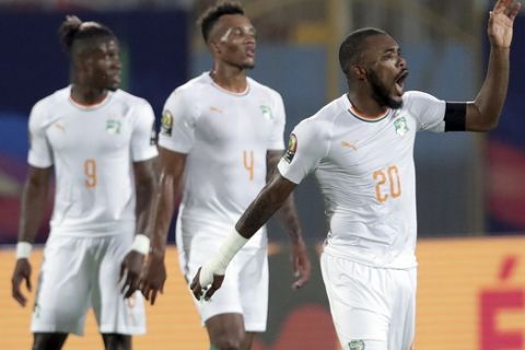Ivory Coast's Die Serey, right, celebrates with teammates after scoring his side's second goal during the African Cup of Nations group D soccer match between Namibia and Ivory Coast in 30 June Stadium in Cairo, Egypt, Monday, July 1, 2019. (AP Photo/Hassan Ammar)