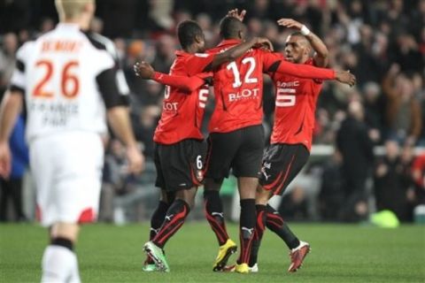 Rennes' players Alexander Tettey, left, Razak Boukari, center, and Yann M'Vila celebrate the first goal against Lens during their French League One soccer match, Saturday, Feb. 26, 2011 in Rennes, western France. (AP Photo/David Vincent)