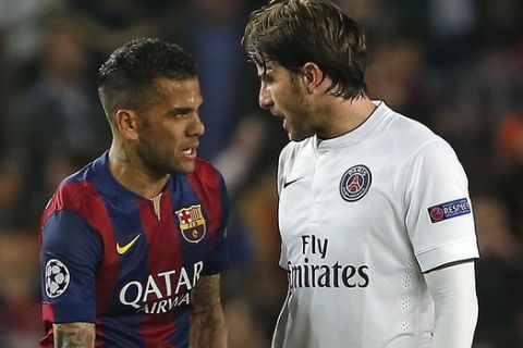Barcelona's Neymar, second left and Dani Alves, greet PSG's Lucas, left, and Maxwell, right, after the Champions League quarterfinal second leg soccer match between FC Barcelona and Paris Saint Germain at the Camp Nou Stadium in Barcelona, Spain, Tuesday, April 21, 2015.  Barcelona won the match 2-0 for a 5-1 aggregate win. (AP Photo/Emilio Morenatti)