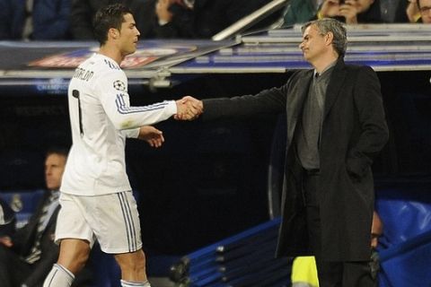 Real Madrid's Portuguese coach Jose Mourinho (R) shakes hands with Real Madrid's Portuguese forward Cristiano Ronaldo (L) during a Champions League football Real Madrid vs Olympique Lyonnais in Santiago Bernabeu Stadium in Madrid on March 16, 2011. AFP PHOTO/ Pedro ARMESTRE . (Photo credit should read PEDRO ARMESTRE/AFP/Getty Images)