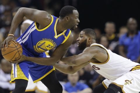 Cleveland Cavaliers center Tristan Thompson, right, defends Golden State Warriors forward Draymond Green (23) during the first half of Game 4 of basketball's NBA Finals in Cleveland, Friday, June 9, 2017. (AP Photo/Tony Dejak)