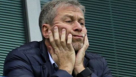 FILE - In this Saturday, Dec. 19, 2015 file photo, Chelsea soccer club owner Roman Abramovich sits in his box before their English Premier League soccer match against Sunderland at Stamford Bridge stadium in London. Chelsea has mastered the art of thriving amid adversity more than any other English club. This offseason looks to be particularly challenging for Chelsea because of a transfer ban, the departure of its best player and the need for another new coach following the departure of Maurizio Sarri. There might also be questions marks about the long-term commitment of Russian billionaire owner Roman Abramovich. (AP Photo/Matt Dunham, File)
