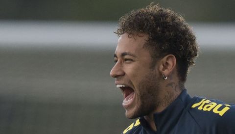 Brazil's Neymar laughs aloud while clowning around with teammates during a national soccer team practice session ahead the World Cup in Russia, at the Granja Comary training center In Teresopolis, Brazil, Friday, May 25, 2018. Neymar, the worlds highest paid soccer player, is nearly recovered from a foot operation and has joined 16 of his teammates in Teresopolis, looking ahead to competing in Russia at the World Cup in July. (AP Photo/Leo Correa)