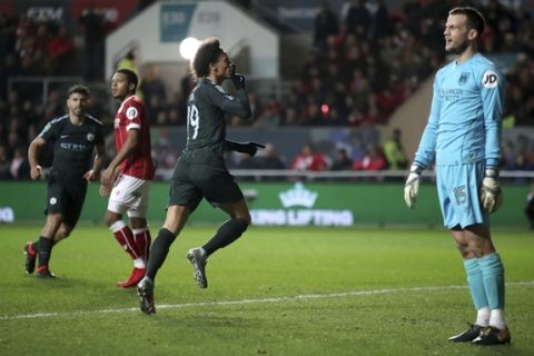 Manchester City's Leroy Sane, centre, celebrates scoring his side's first goal of the game during the English League Cup semi final, second leg match against Bristol City at Ashton Gate, Bristol, England, Tuesday, Jan. 23, 2018. (Nick Potts/PA via AP)