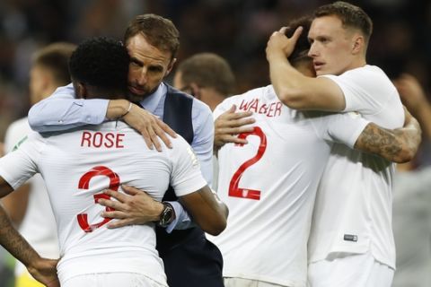 England head coach Gareth Southgate, 2nd left, comforts England's Danny Rose, left, after loosing the semifinal match between Croatia and England at the 2018 soccer World Cup in the Luzhniki Stadium in Moscow, Russia, Wednesday, July 11, 2018. (AP Photo/Francisco Seco)