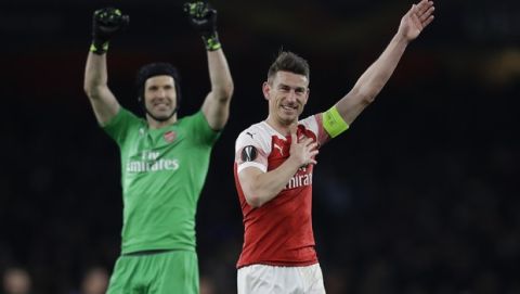 Arsenal's Laurent Koscielny, right, and goalkeeper Petr Cech celebrate after the Europa League first leg quarterfinal soccer match between Arsenal and Napoli at Emirates stadium in London, Thursday, April 11, 2019. (AP Photo/Kirsty Wigglesworth)