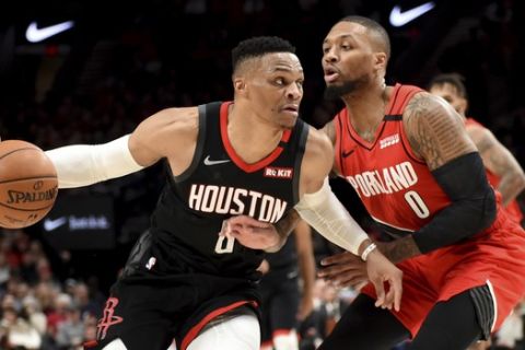 Houston Rockets guard Russell Westbrook, left, drives to the basket on Portland Trail Blazers guard Damian Lillard during the first half of an NBA basketball game in Portland, Ore., Wednesday, Jan. 29, 2020. (AP Photo/Steve Dykes)