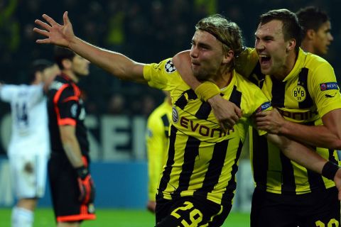 DORTMUND, GERMANY - OCTOBER 24:  Marcel Schmelzer of Dortmund celebrates with Kevin Grosskreutz after scoring his teams second goal  during the UEFA Champions League group D match between Borussia Dortmund and Real Madrid CF at Signal Iduna Park on October 24, 2012 in Dortmund, Germany.  (Photo by Lars Baron/Bongarts/Getty Images)
