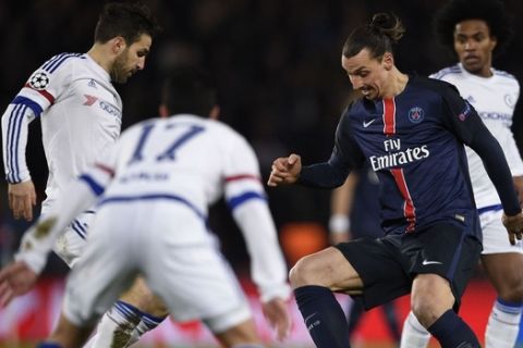 Chelsea's Spanish midfielder Cesc Fabregas (L) vies for the ball with Paris Saint-Germain's Swedish forward Zlatan Ibrahimovic  during the Champions League round of 16 first leg football match between Paris Saint-Germain (PSG) and Chelsea FC on February 16, 2016, at the Parc des Princes stadium in Paris.  AFP PHOTO / FRANCK FIFE / AFP / FRANCK FIFE        (Photo credit should read FRANCK FIFE/AFP/Getty Images)