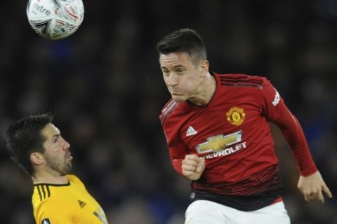 Wolverhampton's Joao Moutinho, left, and Manchester United's Ander Herrera challenge for the ball during the English FA Cup Quarter Final soccer match between Wolverhampton Wanderers and Manchester United at the Molineux Stadium in Wolverhampton, England, Saturday, March 16, 2019. (AP Photo/Rui Vieira)