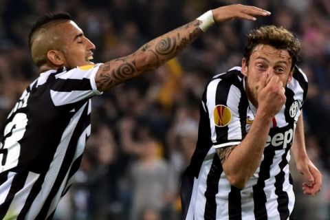 Juventus' midfielder Claudio Marchisio (R) celebrates after scoring a goal with Juventus' Chilean midfielder Arturo Vidal during the UEFA Europa League quarter-final football match Juventus vs Olympique Lyonnais, on April 10, 2014 at the Juventus stadium in Turin.     AFP PHOTO / GIUSEPPE CACACE        (Photo credit should read GIUSEPPE CACACE/AFP/Getty Images)