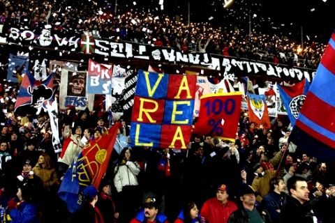 FC Basel's fans celebrate their team, Wednesday, Feb.19, 2003, during the Champions League match between FC Basel and RC Deportivo La Coruna in the St. Jakobspark in Basel, Switzerland.  (AP Photo/KEYSTONE/Dominik Pluess)