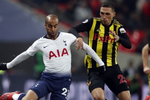 Tottenham's Lucas Moura, left, vie for the ball with Watford's Jose Holebas during the English Premier League soccer match between Tottenham Hotspur and Watford at Wembley Stadium in London, Wednesday, Jan. 30, 2019.(AP Photo/Frank Augstein)