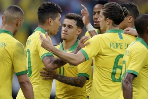 Brazil's Roberto Firmino, 2nd left, celebrates scoring his side's 6th goal with teammates during a friendly soccer match against Honduras at the Beira Rio stadium in Porto Alegre, Brazil, Sunday, June 9, 2019. Brazil opens the Copa America tournament next Friday against Bolivia in Sao Paulo. (AP Photo/Edison Vara)