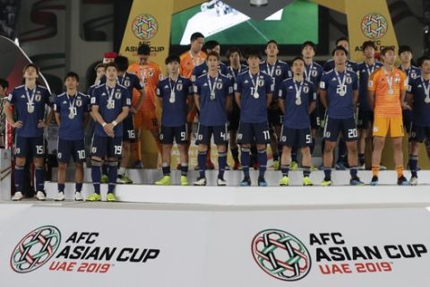 Players of Japan stand on the podium after loosing the AFC Asian Cup final match between Japan and Qatar in Zayed Sport City in Abu Dhabi, United Arab Emirates, Friday, Feb. 1, 2019. (AP Photo/Hassan Ammar)