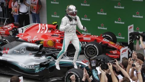 Mercedes driver Lewis Hamilton, of Britain, celebrates winning the Brazilian Formula One Grand Prix at the Interlagos race track in Sao Paulo, Brazil, Sunday, Nov. 11, 2018. (AP Photo/Andre Penner)
