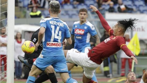Roma's Chris Smalling kicks the ball to save his goal during an Italian Serie A soccer match between Roma and Napoli, at the Olympic stadium in Rome, Saturday, Nov. 2, 2019. (AP Photo/Gregorio Borgia)