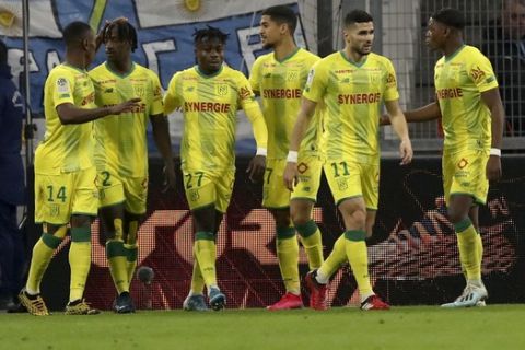 Nantes' Kader Bamba, second left, celebrates his goal with Nantes' players during the French League One soccer match between Marseille and Nantes at the Stade Velodrome in Marseille, southern France, Sunday Feb. 22, 2020. (AP Photo/Daniel Cole)
