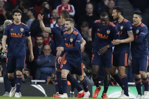 Valencia's Mouctar Diakhaby, third from right, celebrates with teammates after scoring the opening goal during the Europa League semifinal first leg soccer match between Arsenal and Valencia at the Emirates stadium in London, Thursday, May 2, 2019. (AP Photo/Kirsty Wigglesworth)