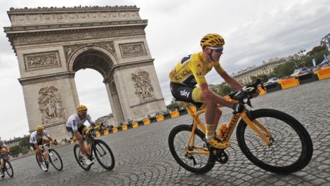 Britain's Chris Froome, wearing the overall leader's yellow jersey, is followed by teammate Vasil Kiryenka of Belarus as they pass the Arc de Triomphe during the twenty-first and last stage of the Tour de France cycling race over 103 kilometers (64 miles) with start in Montgeron and finish in Paris, France, Sunday, July 23, 2017. (AP Photo/Christophe Ena)