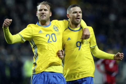 Sweden's Marcus Berg, right, celebrates scoring with teammate Ola Toivonen during the World Cup 2018 group A qualifying match between Sweden and Luxembourg at Friends Arena in Solna, Stockholm, Saturday Oct. 7, 2017. (Soren Andersson/TT via AP)