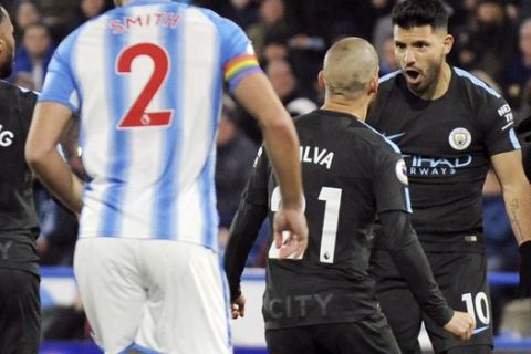 Manchester City's Sergio Aguero, right, celebrates after scoring during the English Premier League soccer match between Huddersfield Town and Manchester City at John Smith's stadium, in Huddersfield, England, Sunday, Nov. 26, 2017. (AP Photo/Rui Vieira)