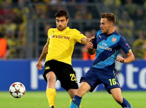 DORTMUND, GERMANY - SEPTEMBER 16:  Sokratis Papastathopoulos of Borussia Dortmund and Aaron Ramsey of Arsenal compete for the ball  during the UEFA Champions League Group D match between Borussia Dortmund and Arsenal at Signal Iduna Park on September 16, 2014 in Dortmund, Germany.  (Photo by Martin Rose/Bongarts/Getty Images)