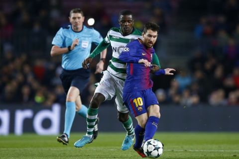 Barcelona's Lionel Messi, right, and Sporting's William Carvalho challenge for the ball during the Champions League Group D soccer match between FC Barcelona and Sporting CP at the Camp Nou stadium in Barcelona, Spain, Tuesday, Dec. 5, 2017. (AP Photo/Manu Fernandez)