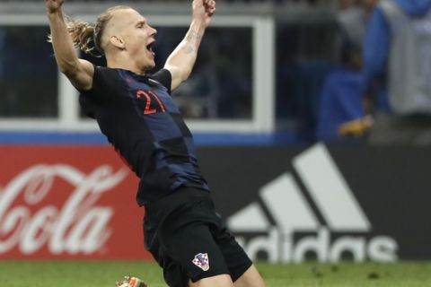 Croatia's Domagoj Vida celebrates after his team advanced to the final during the semifinal match between Croatia and England at the 2018 soccer World Cup in the Luzhniki Stadium in Moscow, Russia, Wednesday, July 11, 2018. (AP Photo/Alastair Grant)