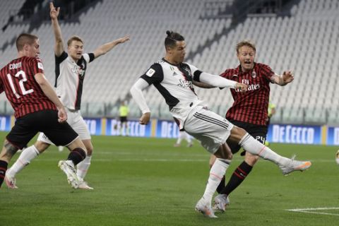 Juventus' Cristiano Ronaldo gets in a shot during an Italian Cup second leg soccer match between Juventus and AC Milan at the Allianz stadium, in Turin, Italy, Friday, June 12, 2020. The match was being played without spectators because of the coronavirus lockdown. (AP Photo/Luca Bruno)