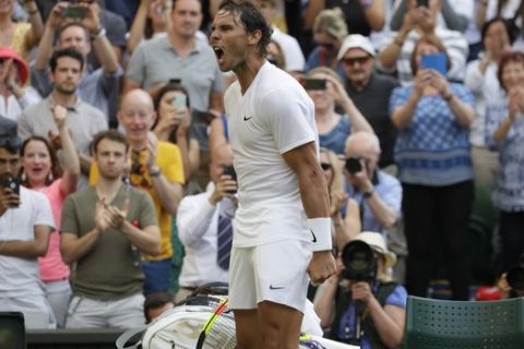 Spain's Rafael Nadal celebrates after beating Australia's Nick Kyrgios in a Men's singles match during day four of the Wimbledon Tennis Championships in London, Thursday, July 4, 2019. (AP Photo/Kirsty Wigglesworth)