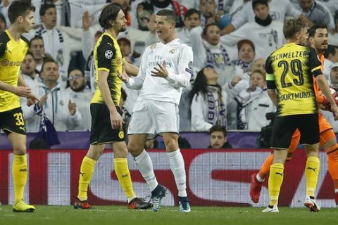 Real Madrid's Cristiano Ronaldo, center, reacts during the Champions League Group H soccer match between Real Madrid and Borussia Dortmund at the Santiago Bernabeu stadium in Madrid, Spain, Wednesday, Dec. 6, 2017. (AP Photo/Paul White)