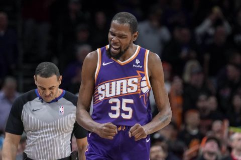 Phoenix Suns' Kevin Durant (35) pumps his fists after the Suns took a 5-point lead against the Sacramento Kings during the second half of an NBA basketball game in Phoenix, Tuesday, Feb. 13, 2024. (AP Photo/Darryl Webb)